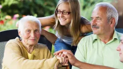Three generations of Family Smiling Together Outdoors