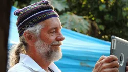 Senior Man wearing a hat and using tablet computer